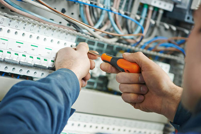 Electrician diagnosing a panel