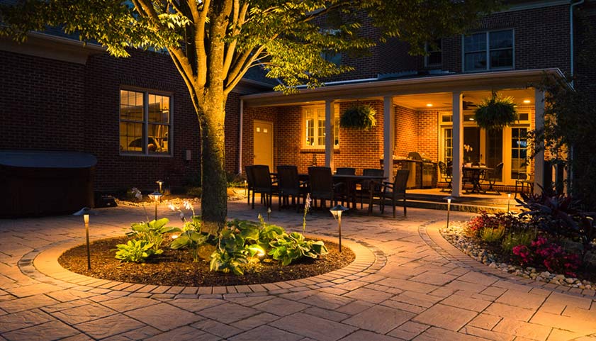Beautifully lit outdoor garden patio at night