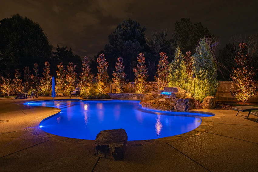 Beautiful lit pool and spa at night